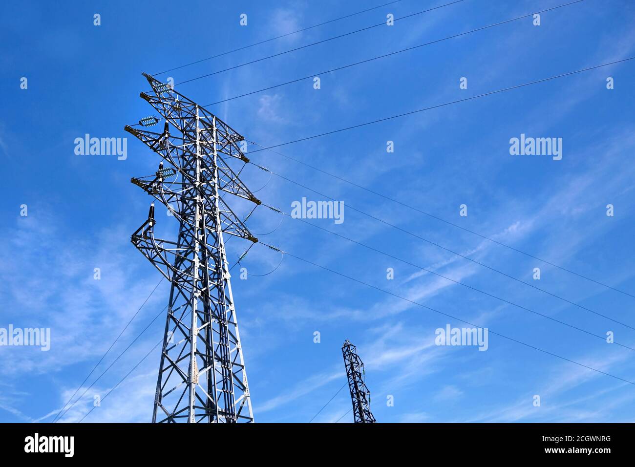 High voltage power line on blue sky background Stock Photo - Alamy