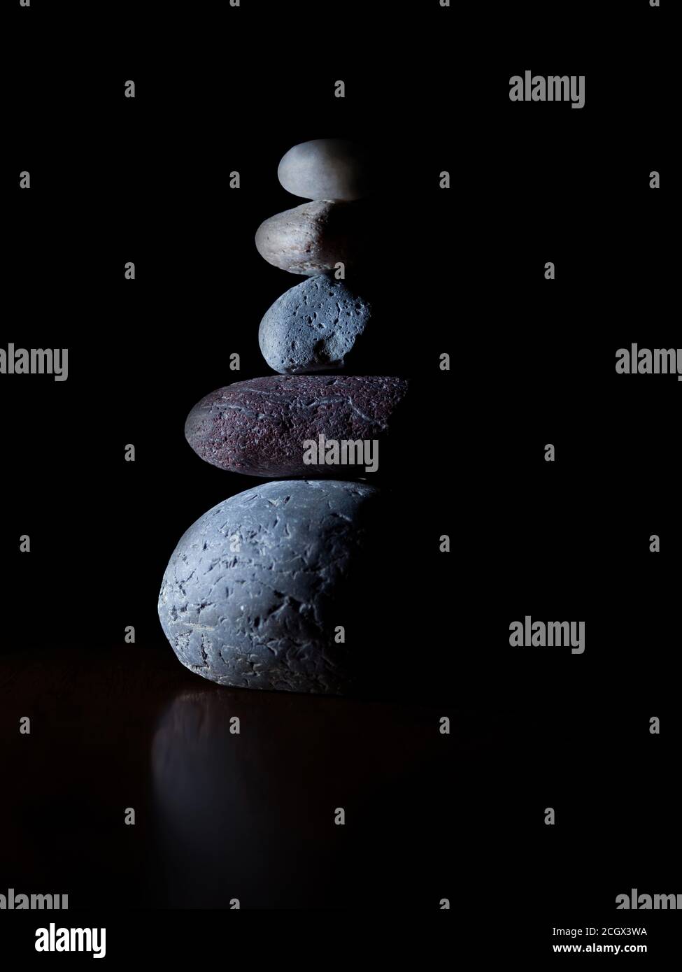 Stacked stones isolated on a black background. Stock Photo