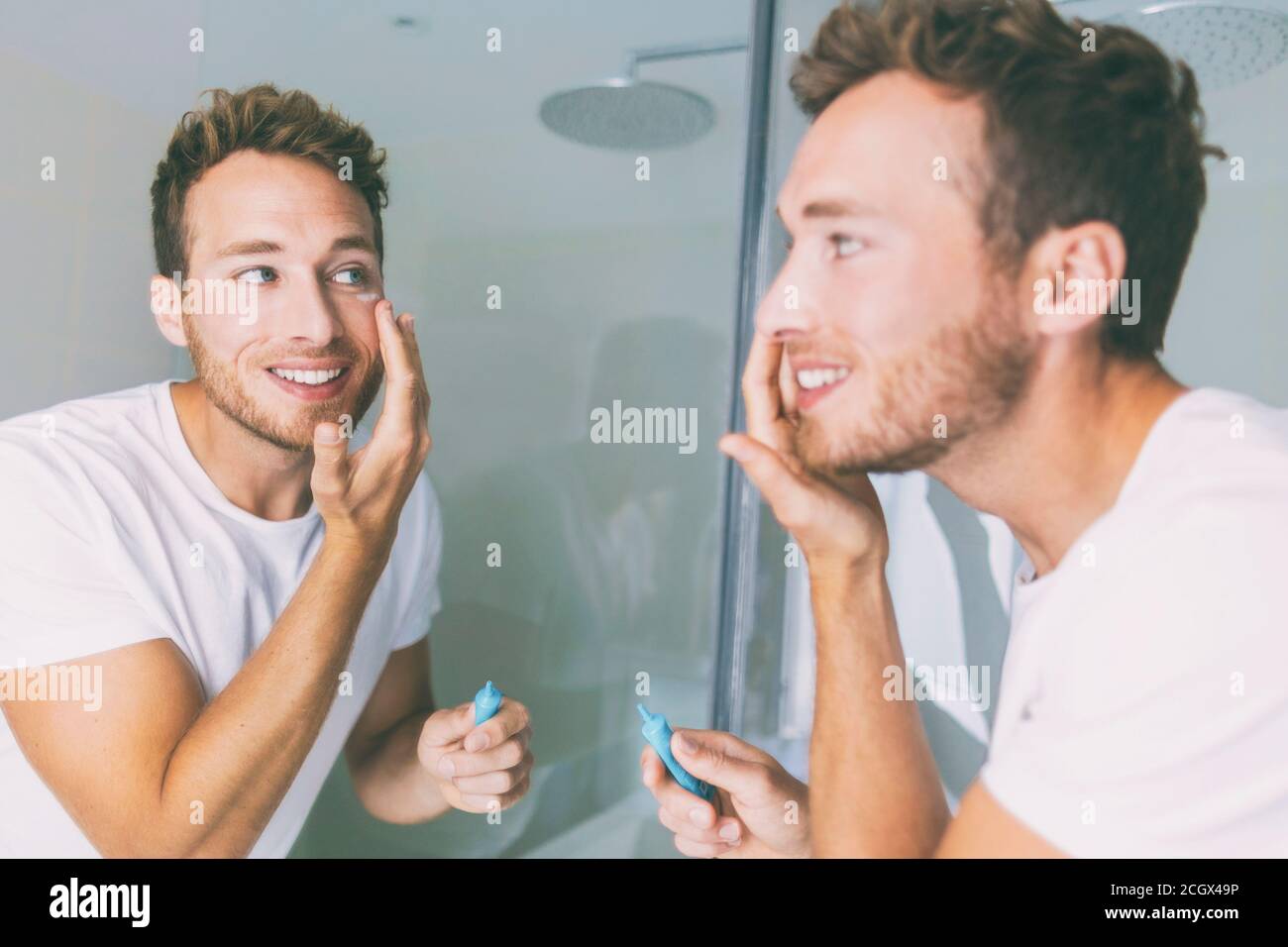 Man putting skincare facial treatment cream on face. Antiaging skin