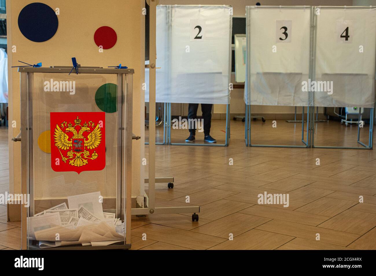 A ballot box with the coat of arms of the Russian Federation with ballots seen at a polling station.In 2020, elections in Russia will be held for three days (from September 11 to 13). A single voting day is on September 13. This year, 17 heads of Federal subjects (governors) and deputies of legislative assemblies of state power in 11 regions of the Russian Federation will be elected in many regions, they will vote for candidates for local authorities, municipalities, for the post of heads of urban economy, mayors of cities and heads of settlements. In the Tambov region, elections of the Govern Stock Photo