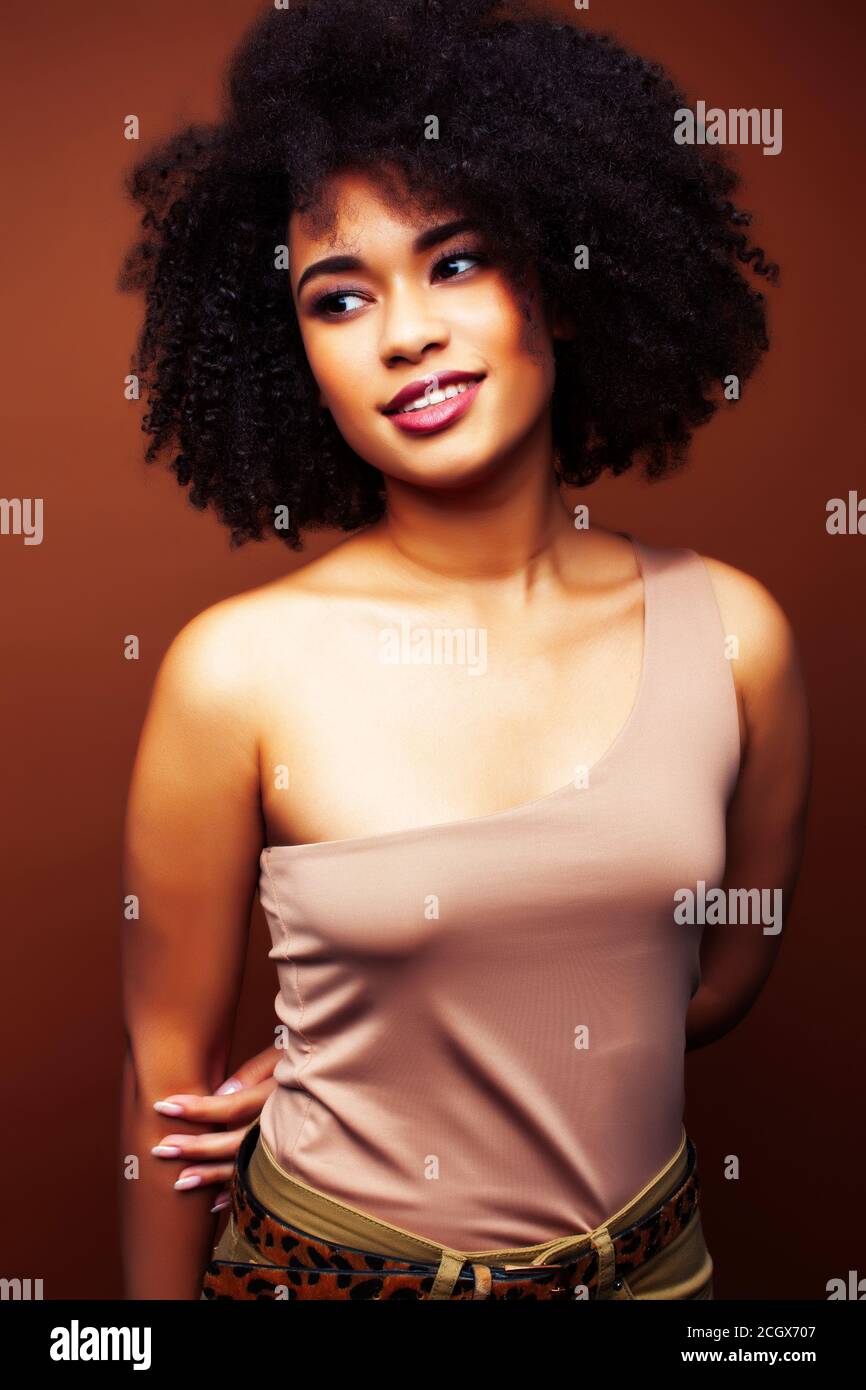 pretty young african american woman with curly hair posing cheerful ...