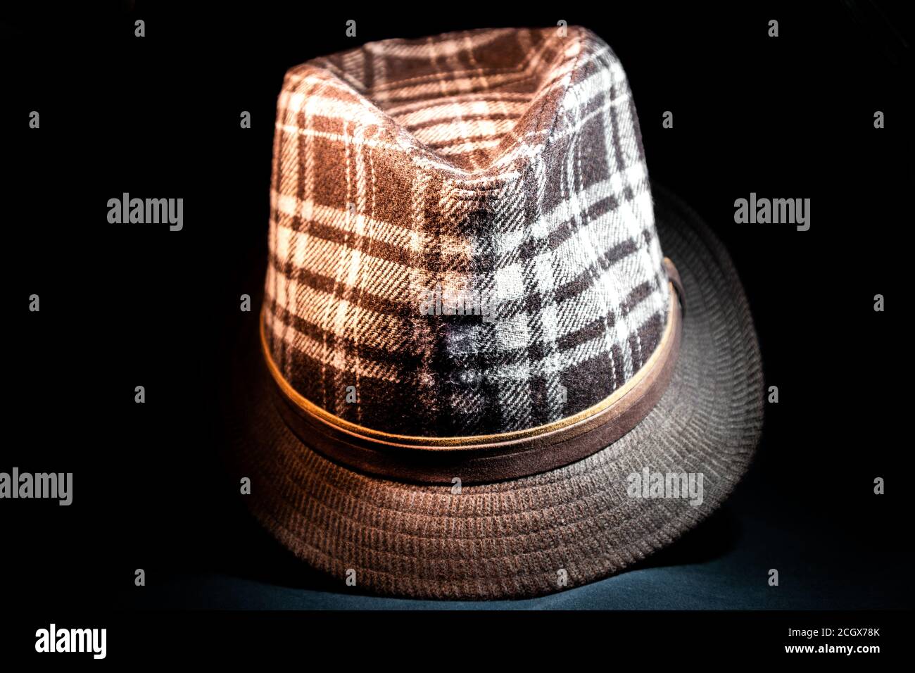 Old fashioned style fedora with modern pattern in darkness facing forward Stock Photo