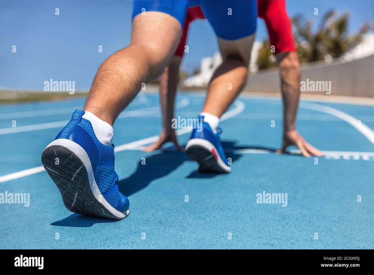 Sprinter waiting for start of race on running tracks at outdoor stadium