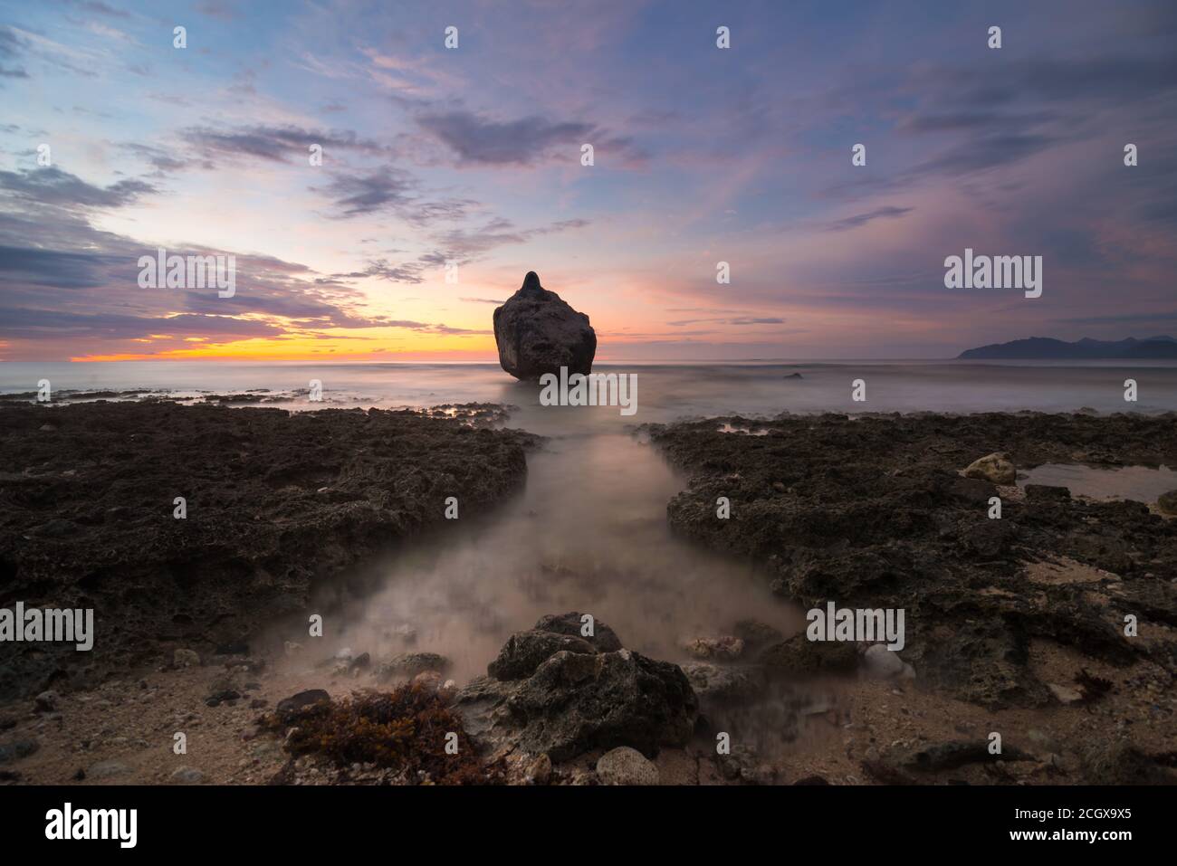 Lone Big Boulder Along Coastal at Sunset, Apatot, San Esteban, Ilocos Sur, Philippines Stock Photo