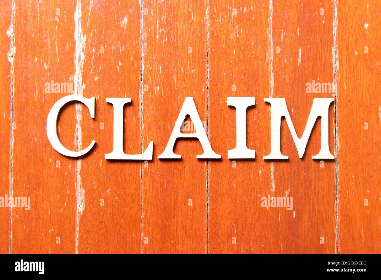 Alphabet letter in word claim on old red color wood plate background ...