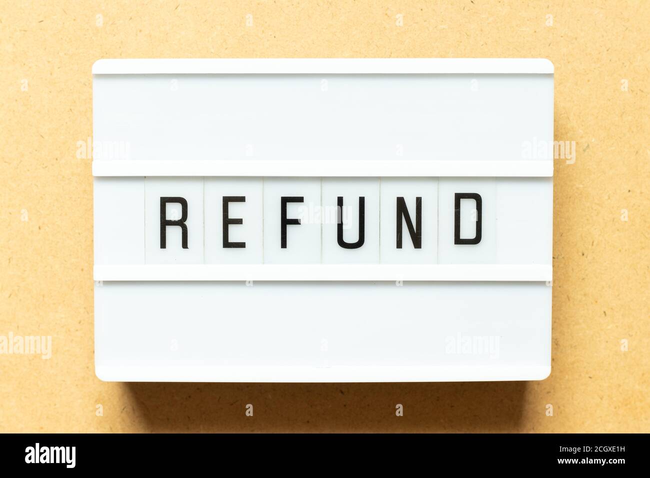 Lightbox with word refund on wood background Stock Photo