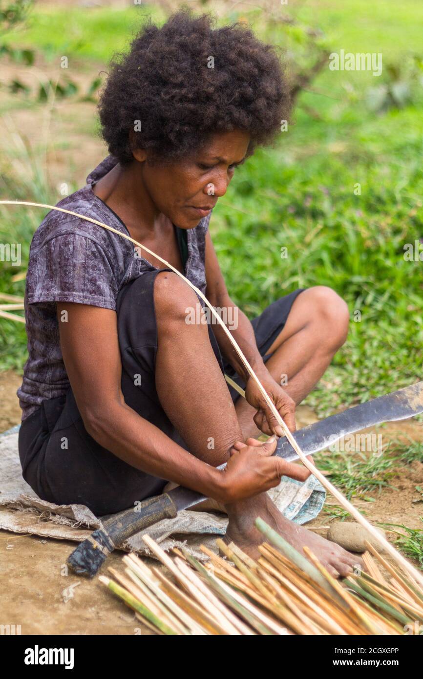 Aeta woman preparing rattan for weaving Stock Photo Alamy