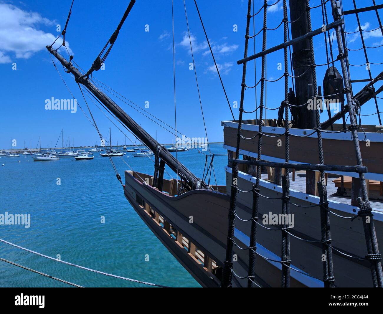 Harbor with modern boats and rigging of old fashioned sailing ship ...