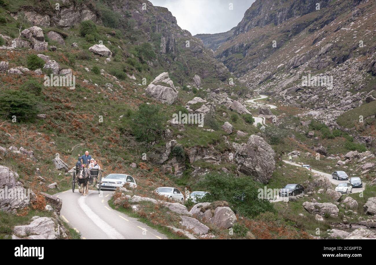 Gap of Dunloe, Killarney, Kerry, Ireland. 12th September, 2020. A family take a leisurely afternoon drive on a jaunting car followed by a stream of traffic through the narrow road at the Gap of Dunloe, Co. Kerry, Ireland.  - Credit; David Creedon / Alamy Live News Stock Photo