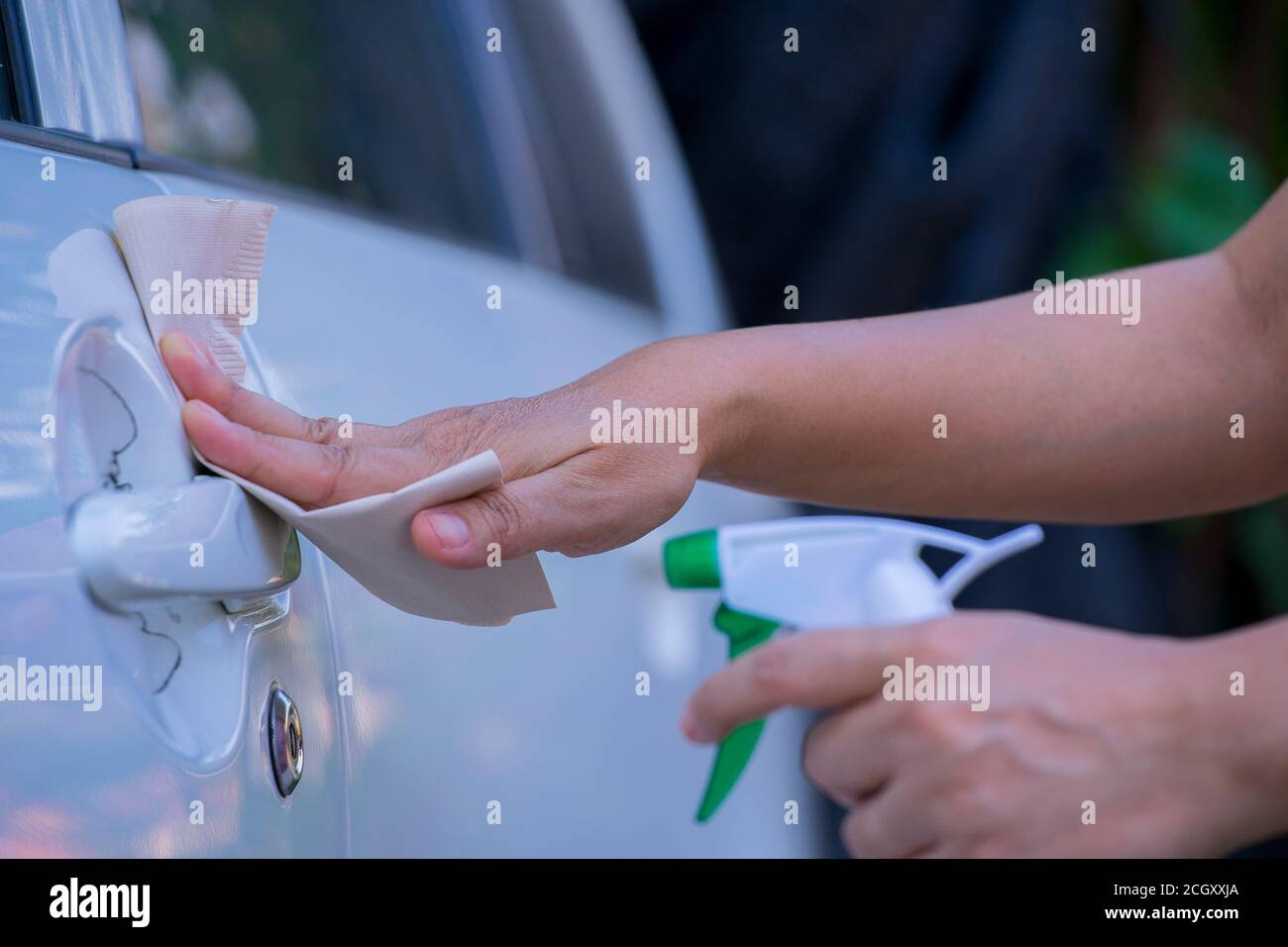 Asian women spry soap and clean car door handle with napkin Stock Photo Alamy