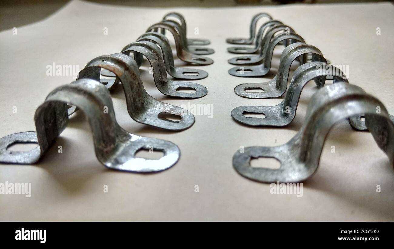 An industrial fixture clips or clamps isolated on flat white background or surface with