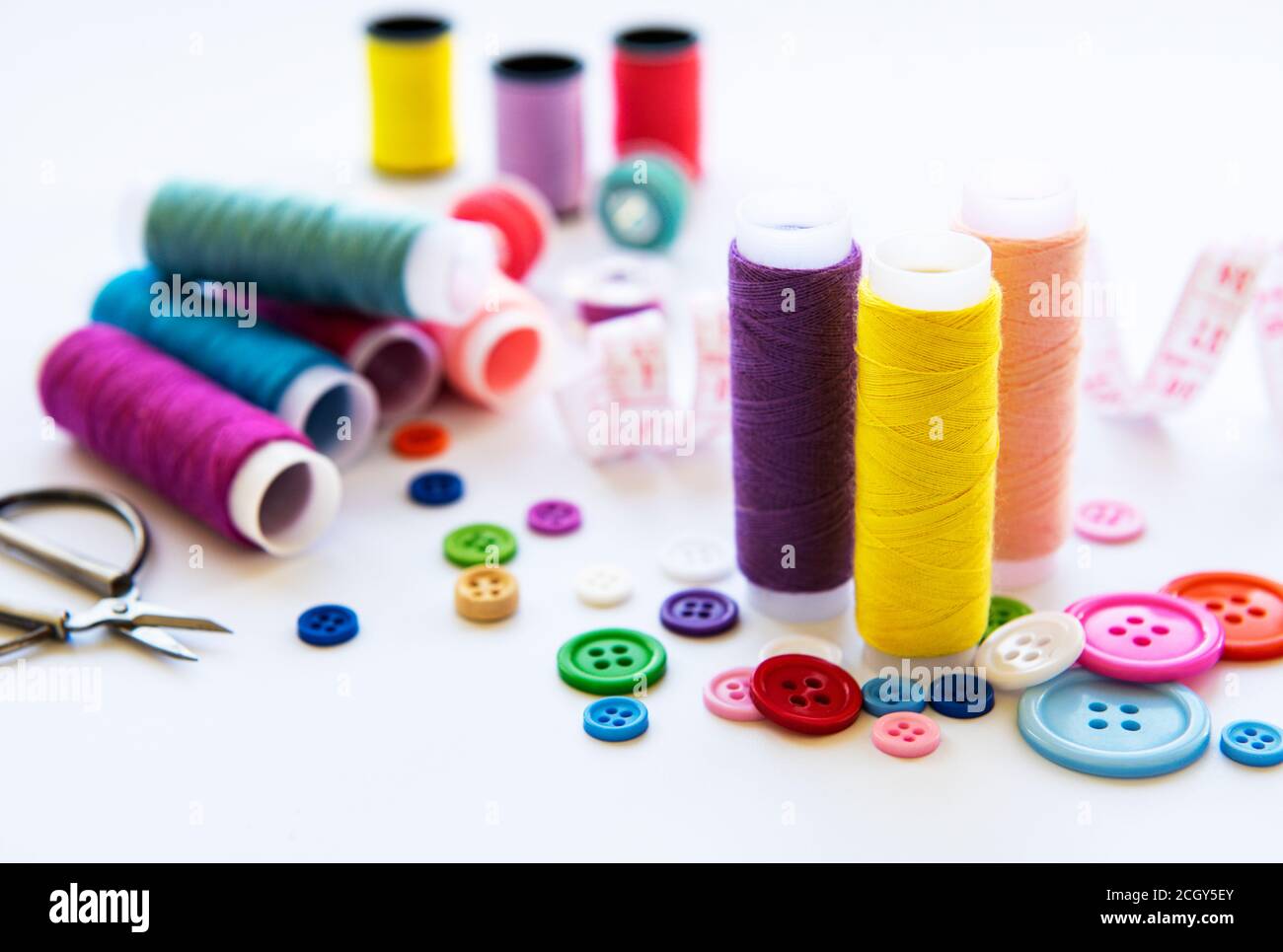 Color threads and sewing accessories on white background Stock Photo ...