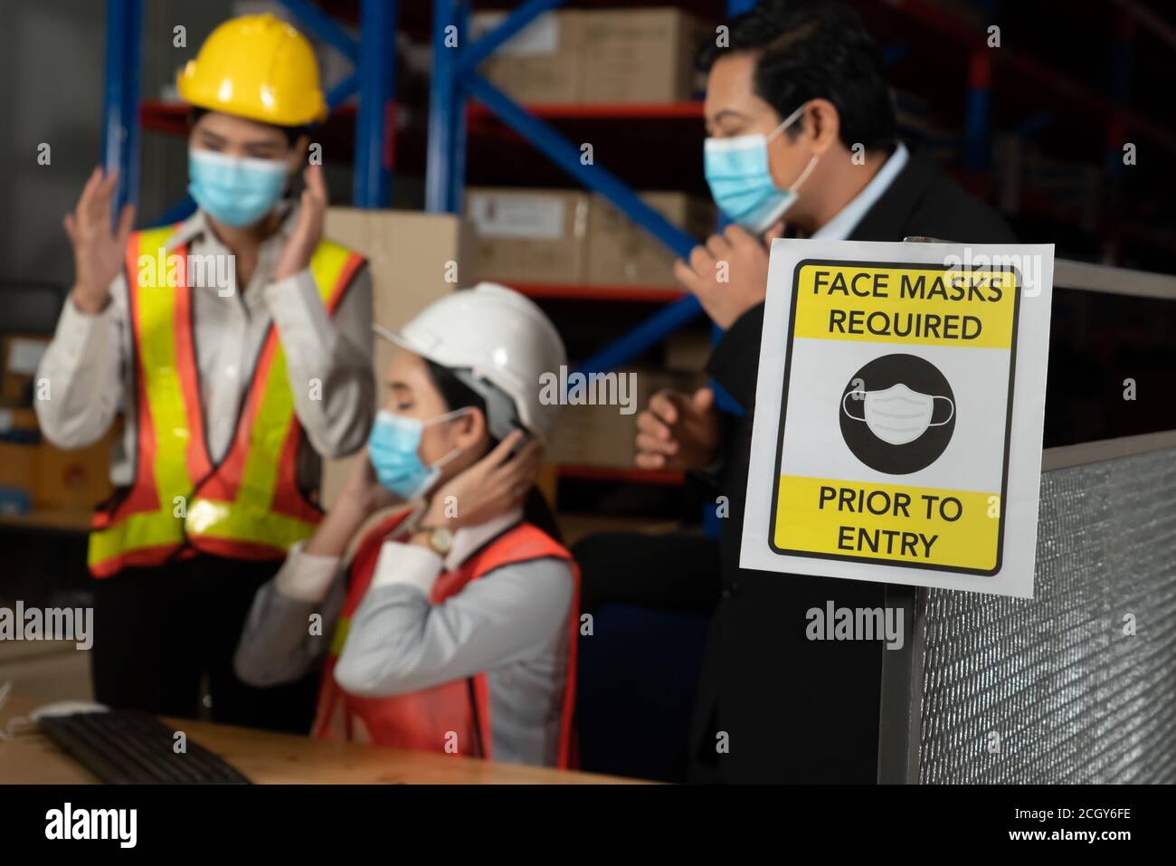 Caution sign in factory warning to industry labor worker to prevent Covid-19 Coronavirus spreading during job business reopening period after epidemic crisis . Working safely concept . Stock Photo
