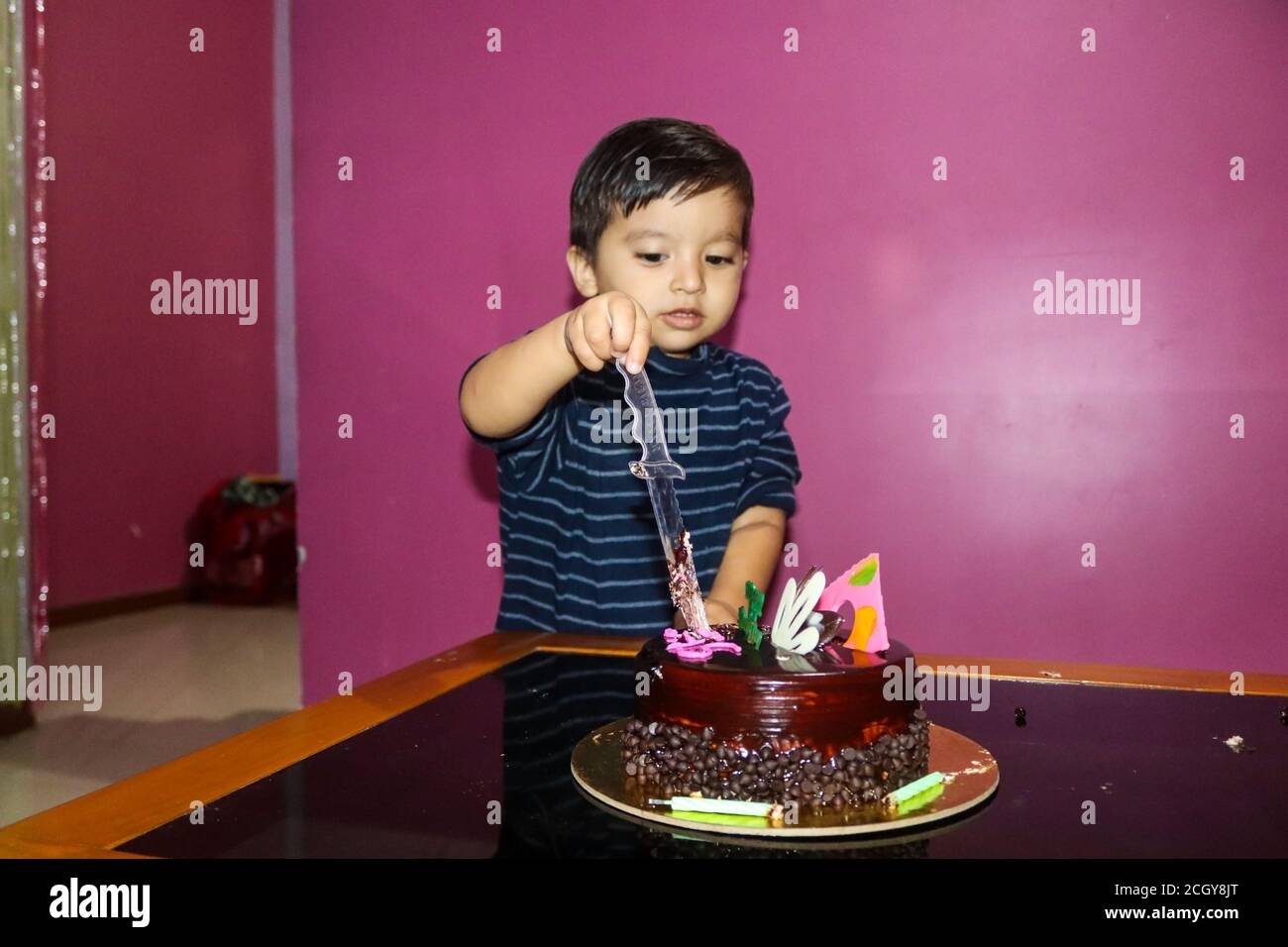 Photo of Indian little baby boy cutting cake. Soft focus image Stock Photo  - Alamy