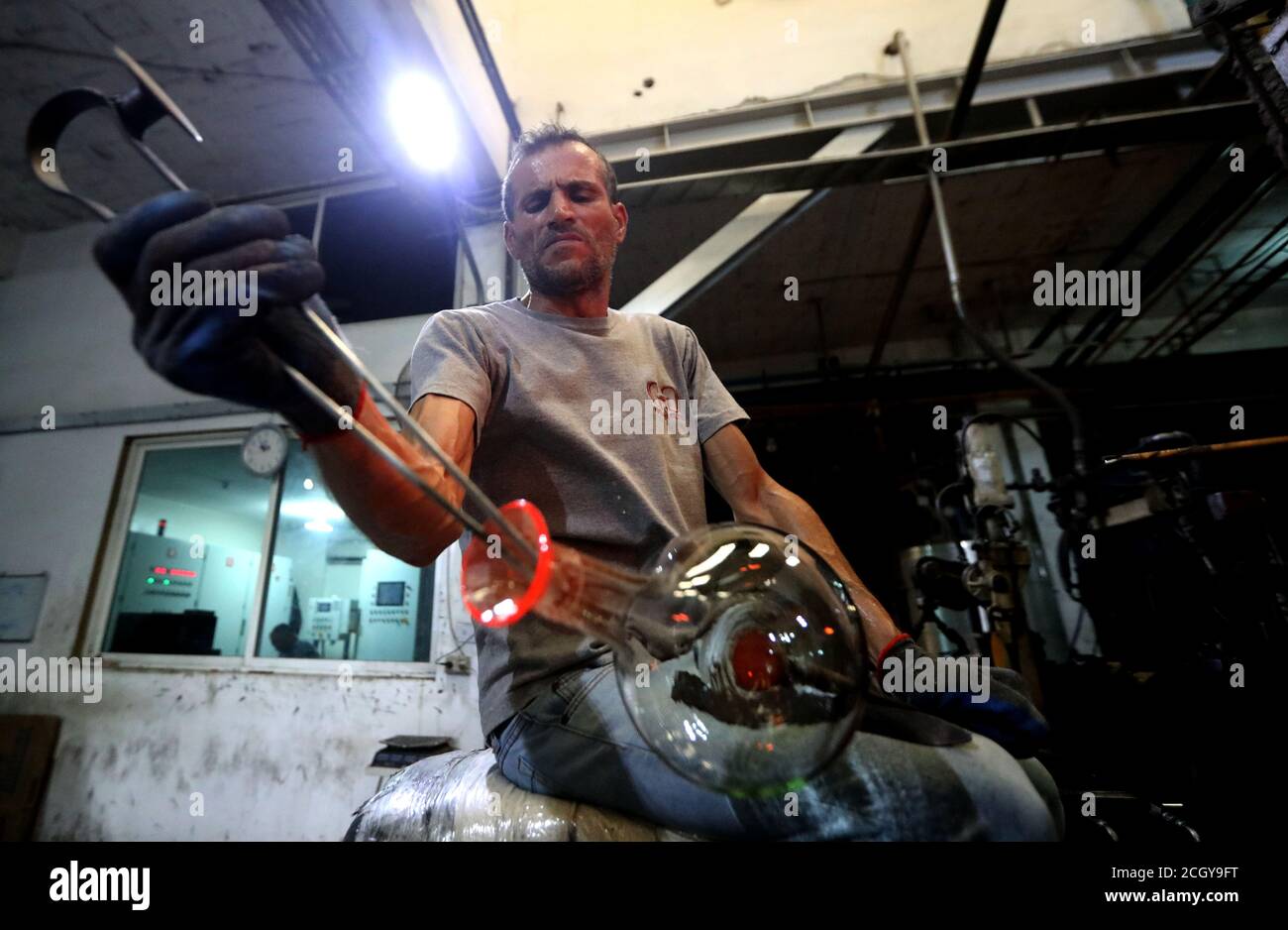 Tripoli, Lebanon. 12th Sep, 2020. A worker makes glassware at a glass