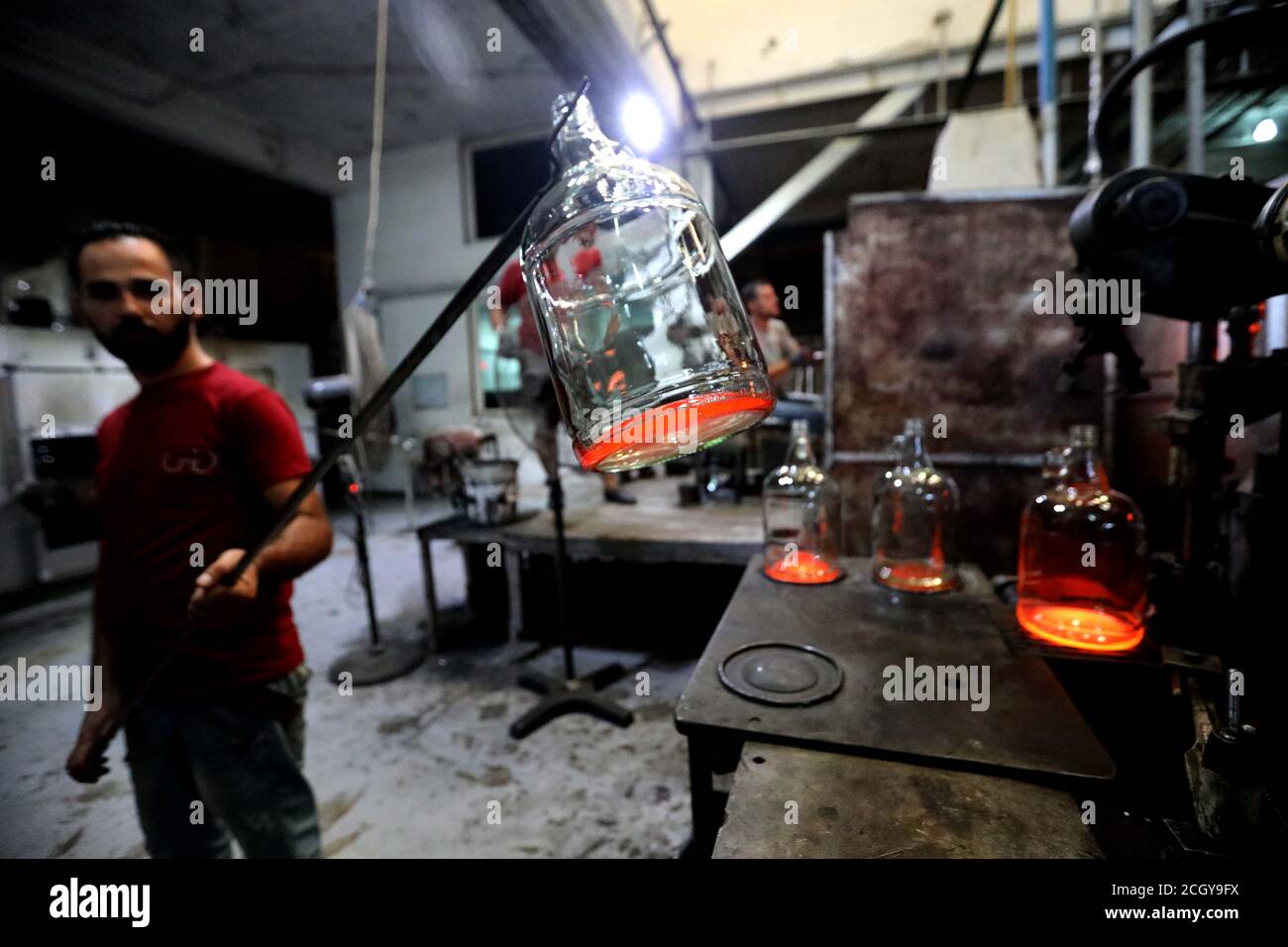 Tripoli, Lebanon. 12th Sep, 2020. A worker makes glassware at a glass