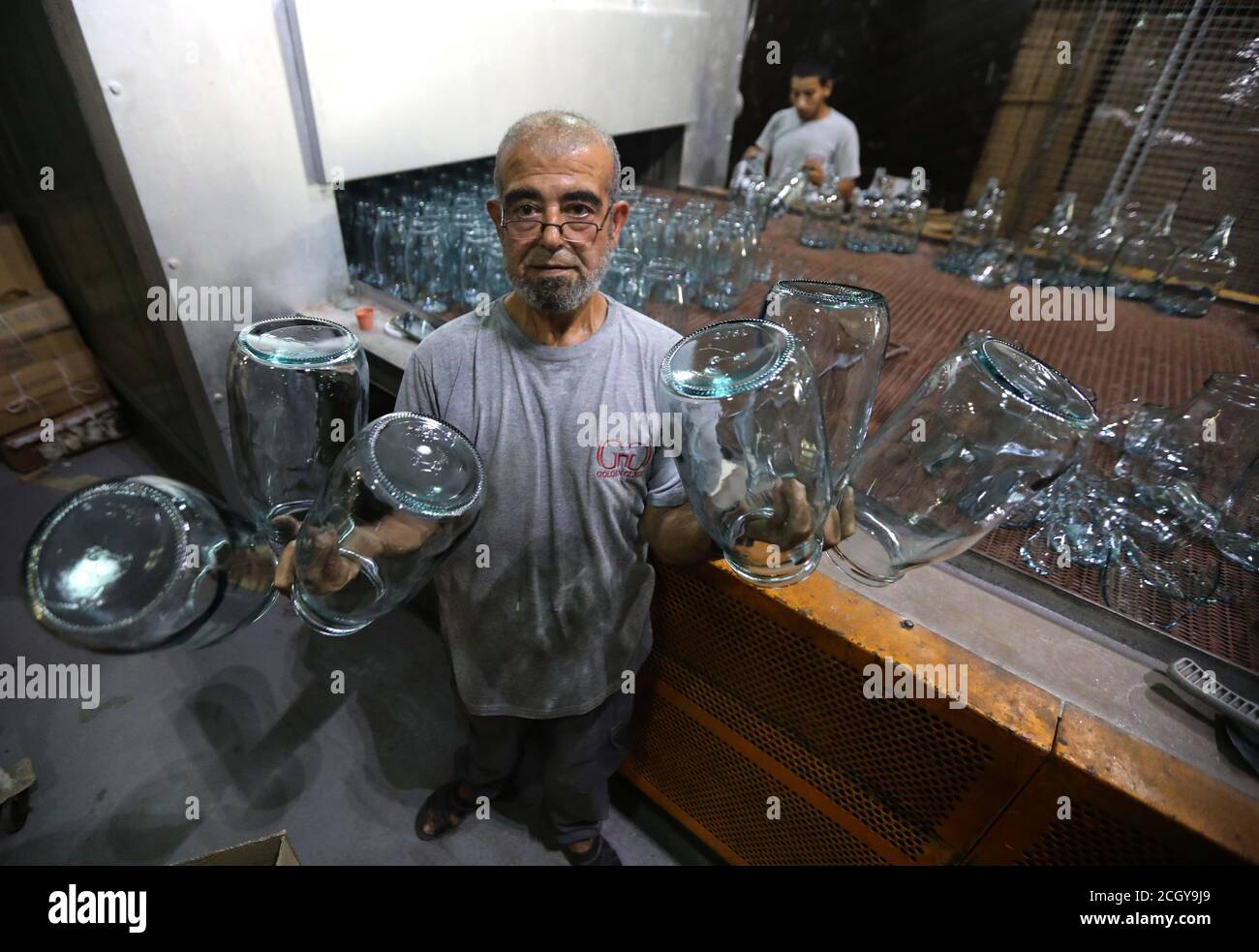 Tripoli, Lebanon. 12th Sep, 2020. A worker shows glassware at a glass