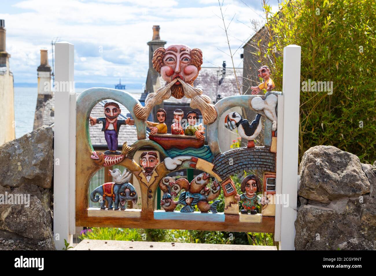 Handmade gate with carved figures on a house in Lower Largo, Fife, SCotland. Stock Photo