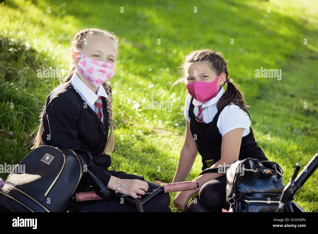 Two young school children wearing school uniform and face masks looking to camera, Scotland, UK Stock Photo