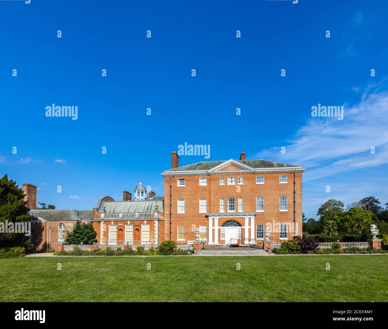 Front view of Hatchlands Park, a red-brick country house with surrounding gardens in East Clandon near Guildford, Surrey, south-east England Stock Photo
