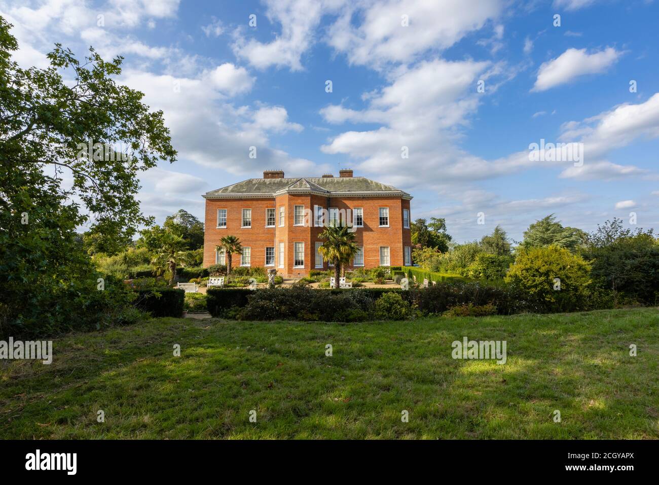 Side view of Hatchlands Park, a red-brick country house with surrounding gardens in East Clandon near Guildford, Surrey, south-east England Stock Photo
