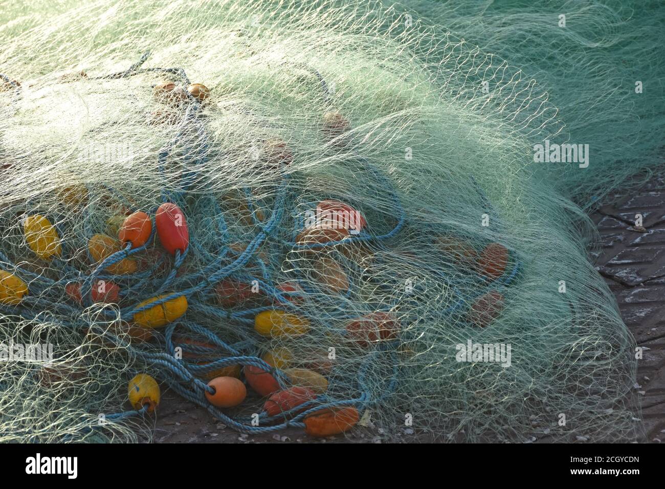 Fishing net on the ground Stock Photo - Alamy