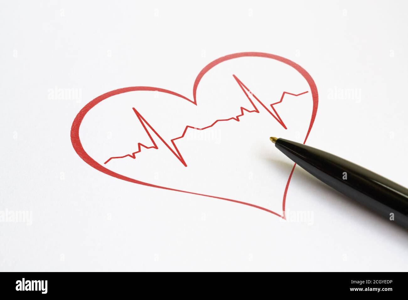 Red heart with stylized cardiogram and a pen on bright background Stock Photo