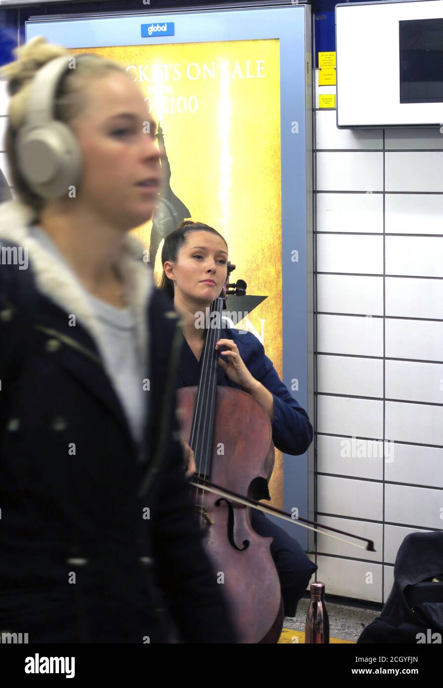 London busker playing the cello at Piccadilly tube station underground Stock Photo