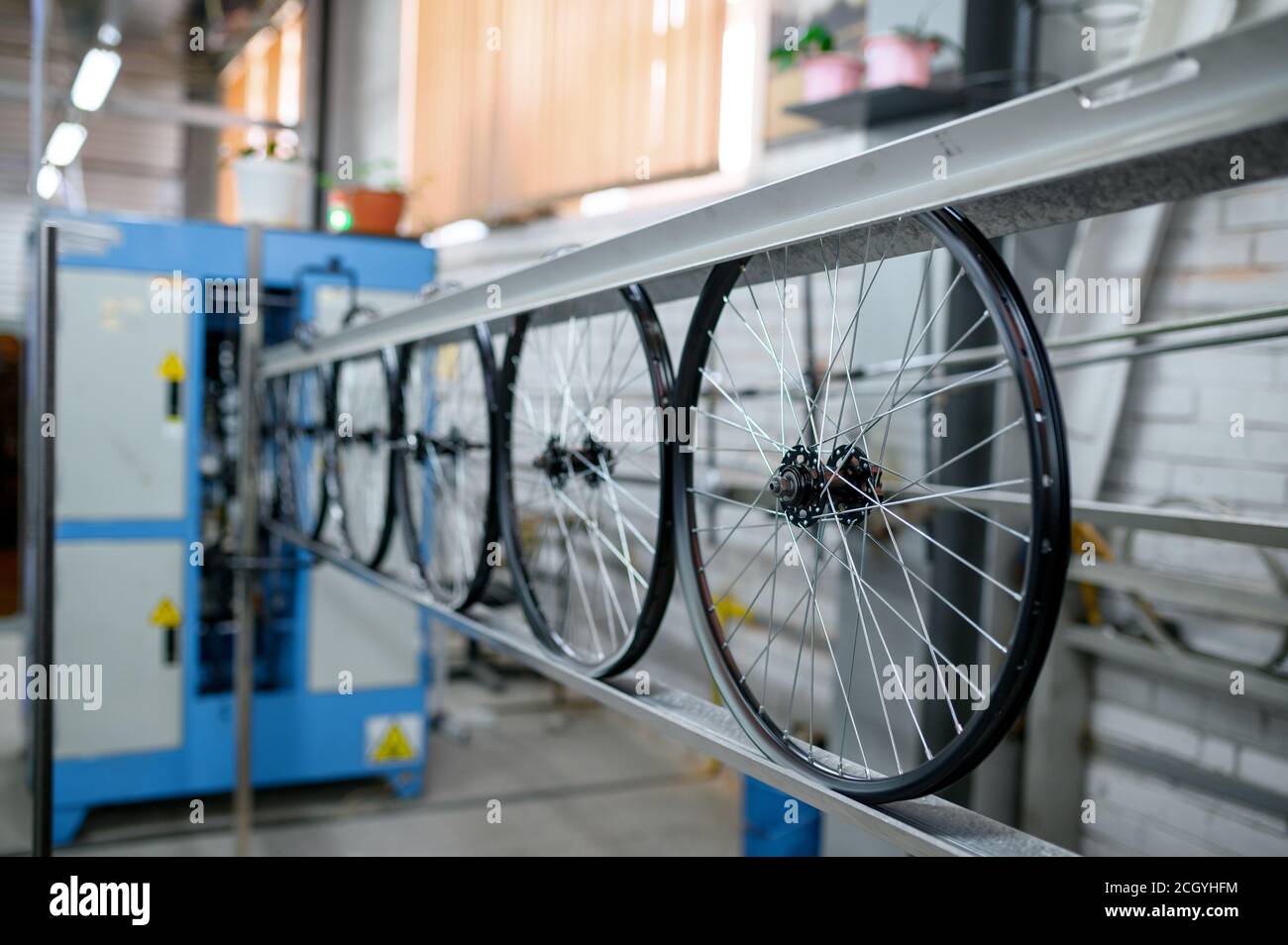 New aluminum bicycle wheels on assembly line Stock Photo Alamy