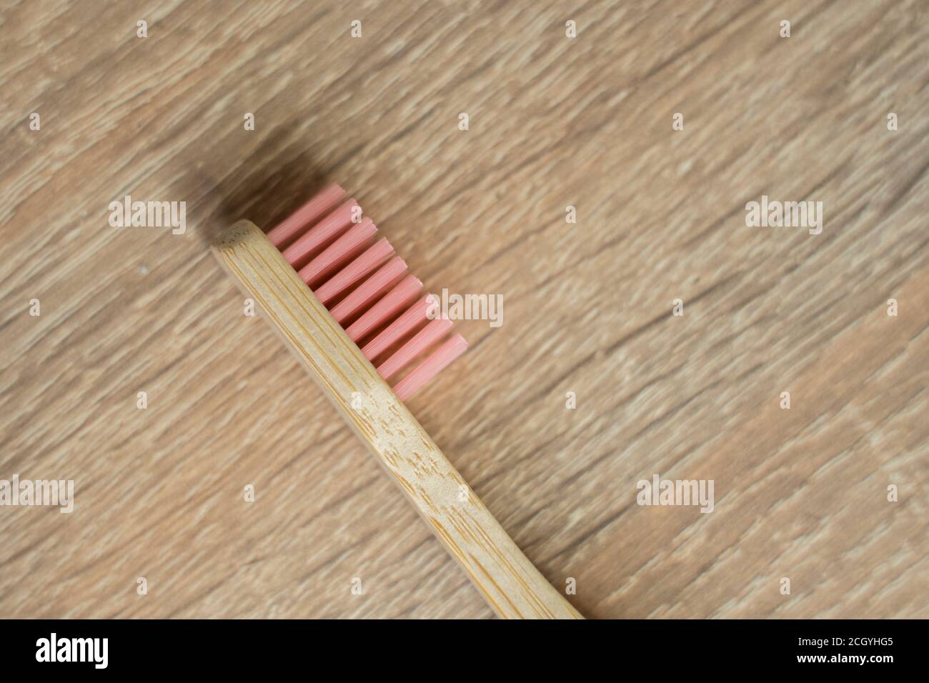 Eco-friendly bamboo toothbrush on a table. Zero-waste. Biodegradable toothbrush. Stock Photo