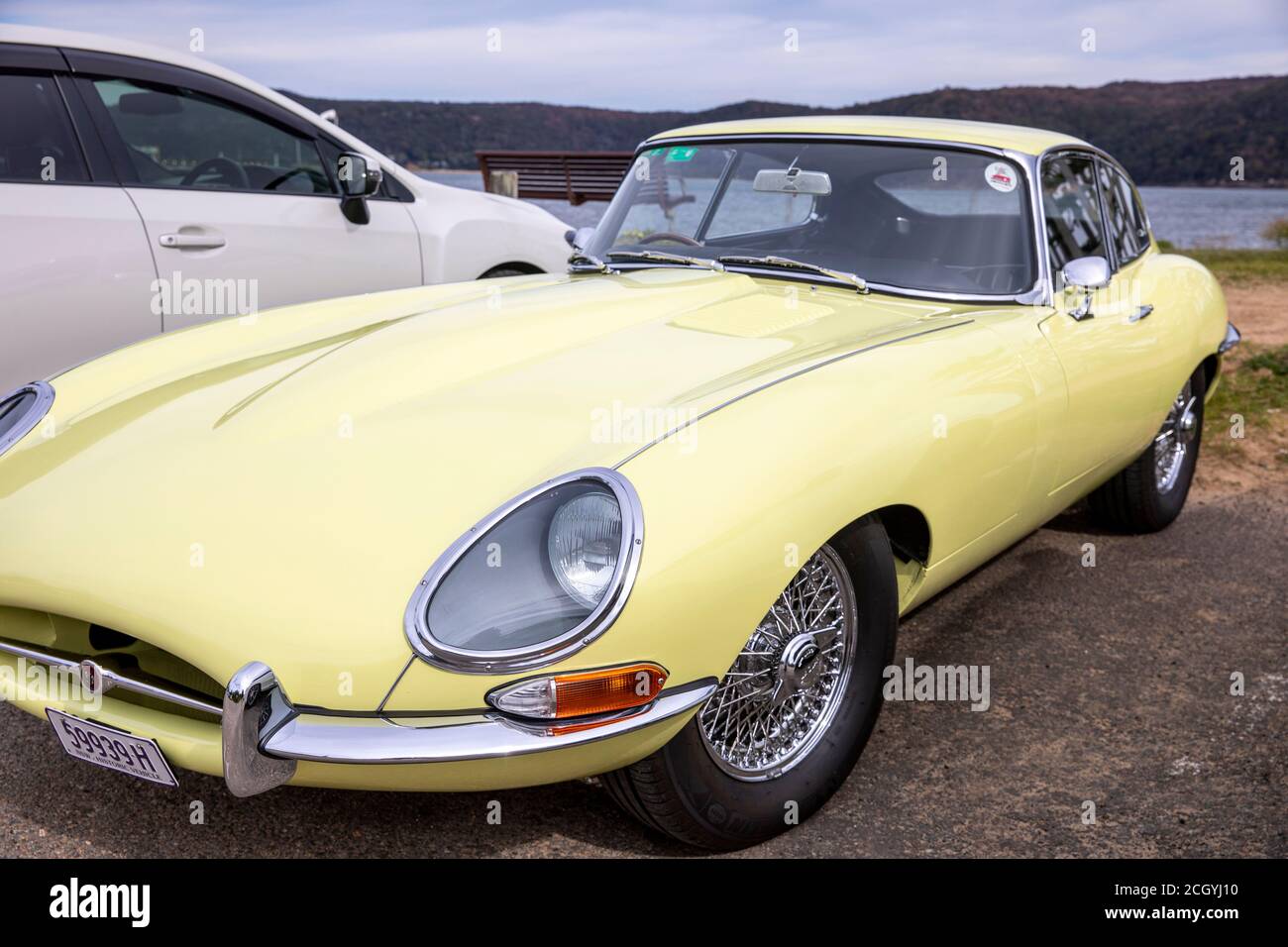 1966 series 1 Jaguar E type in yellow front view parked at Palm Beach in Sydney,NSW,Australia Stock Photo