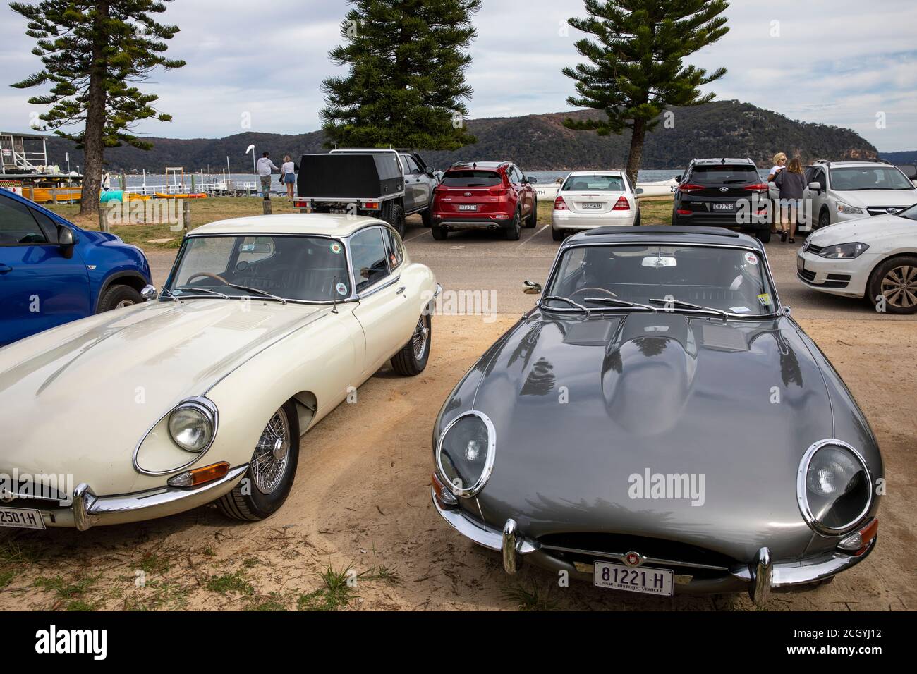 Two classic jaguar e type cars at palm beach,Sydney,Australia, 1965 grey and 1967 model in cream Stock Photo