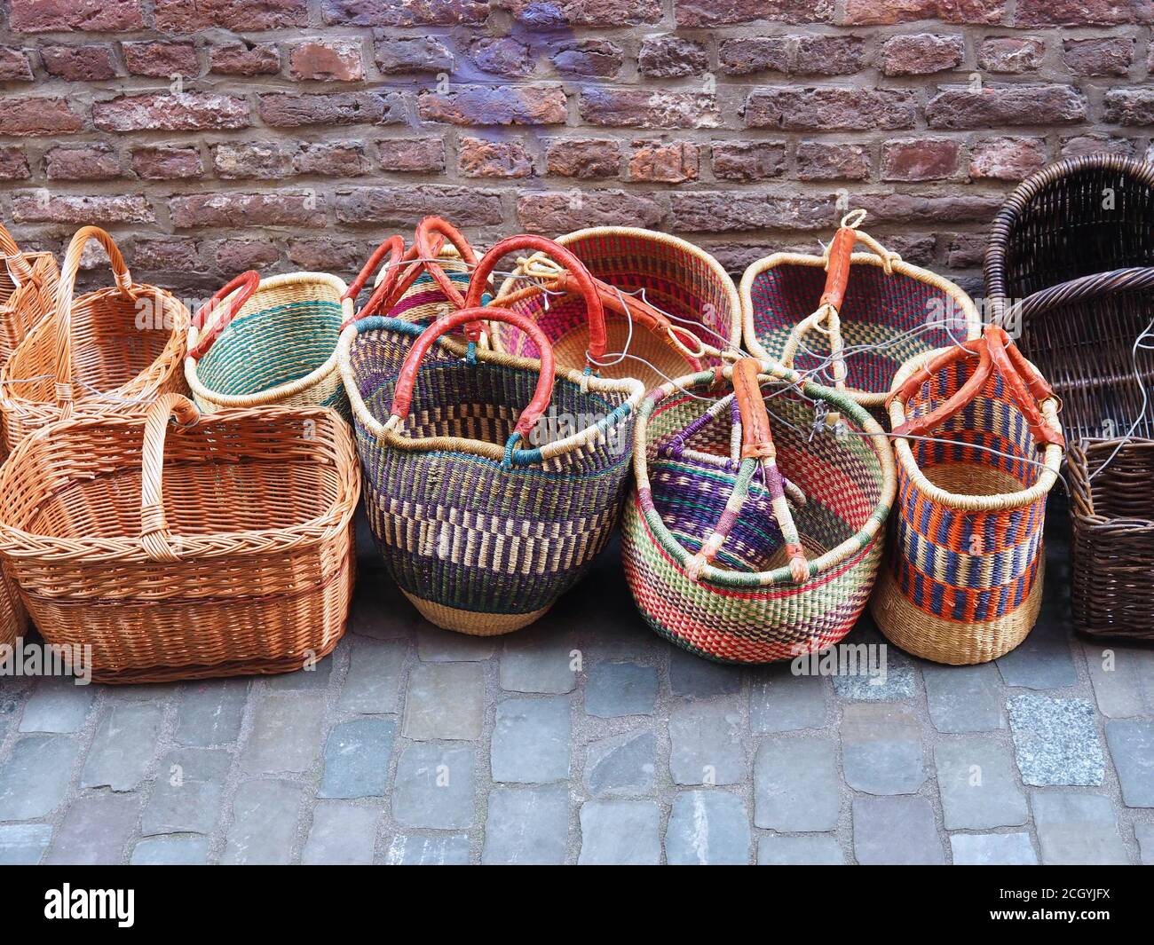 Colorful woven shopping baskets at a street market Stock Photo Alamy