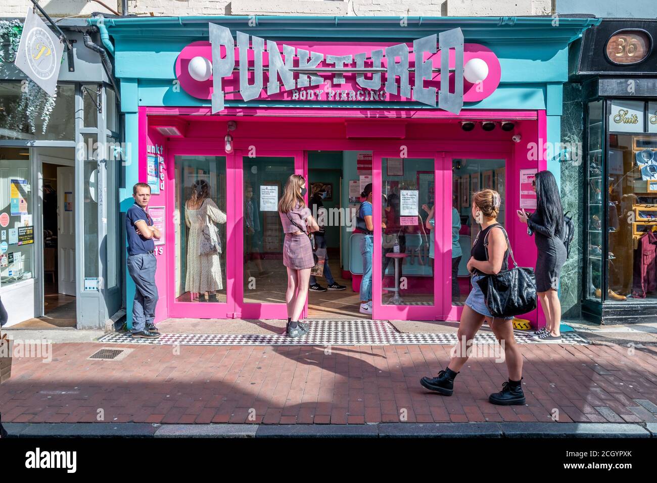 Brighton, UK. September 12th 2020.People waiting outside a piercing shop in  Brighton city centre Credit: Andrew Hasson/Alamy Live News Stock Photo -  Alamy