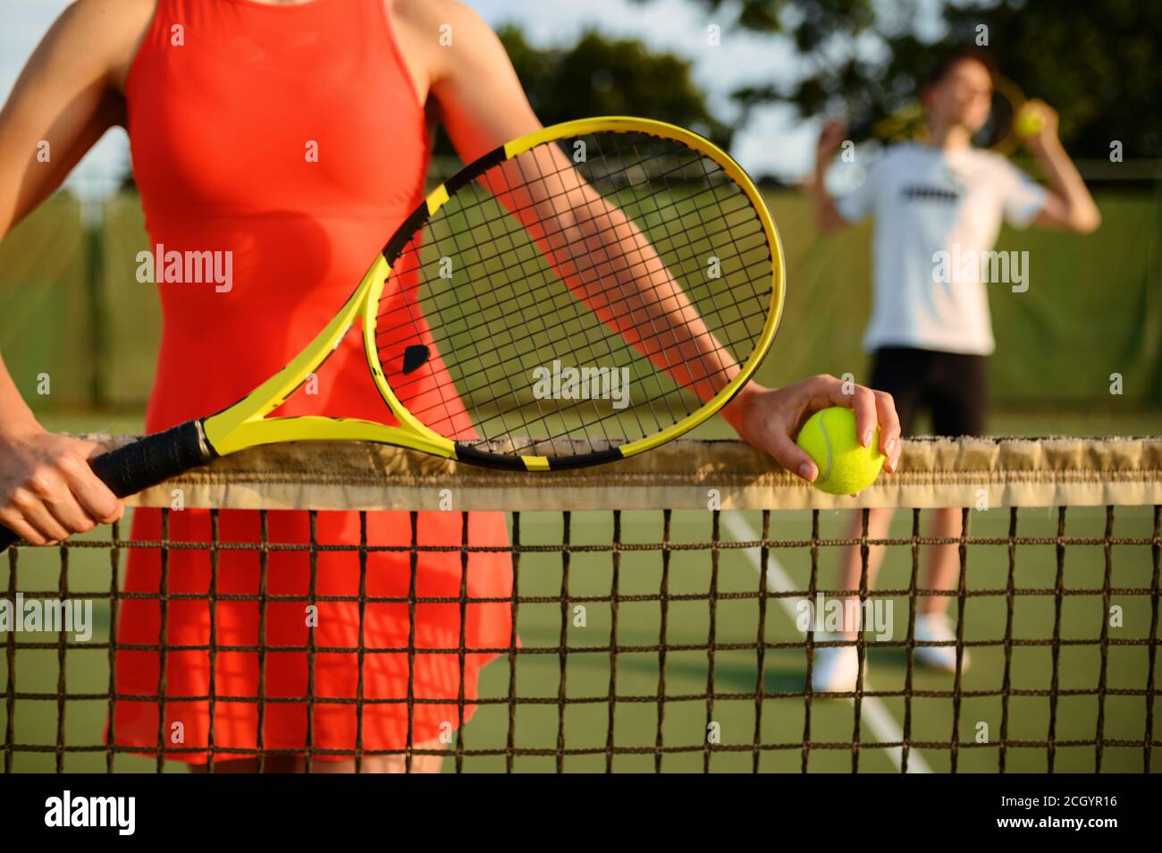 Male and female tennis players with rackets Stock Photo Alamy