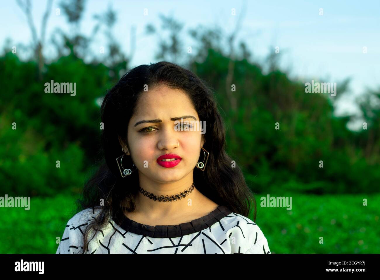 https://c8.alamy.com/comp/2CGYR7J/an-indian-model-with-closeup-beautiful-face-and-green-blurred-background-of-outside-trees-2CGYR7J.jpg