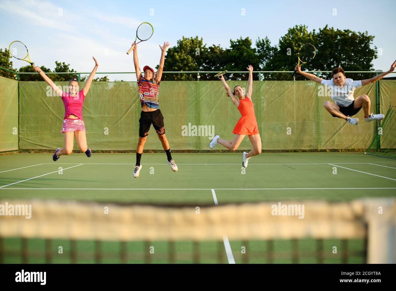 Mixed doubles tennis, players jump near the net Stock Photo Alamy