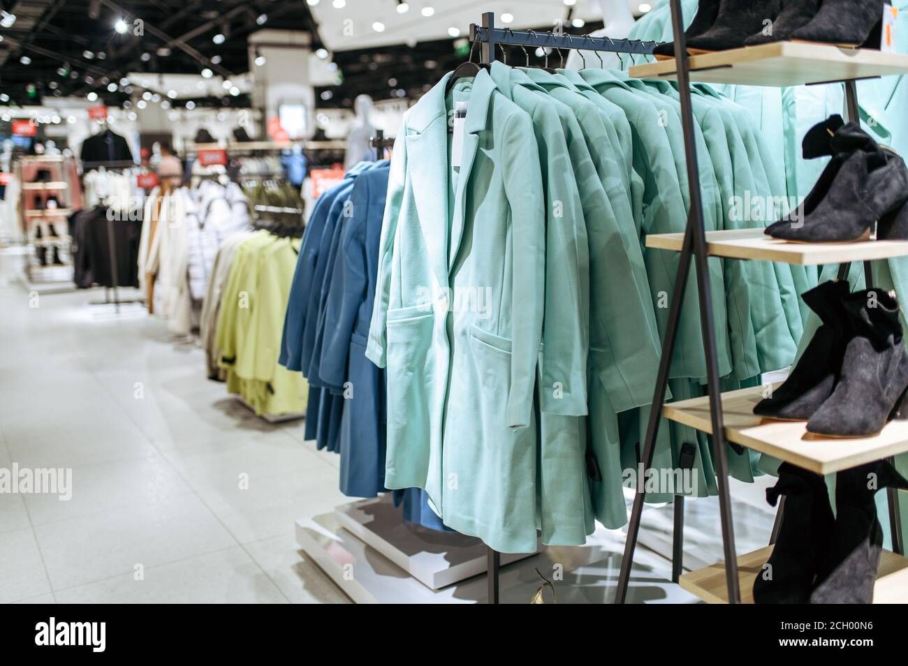 Clothes, coats on racks in clothing store, nobody Stock Photo