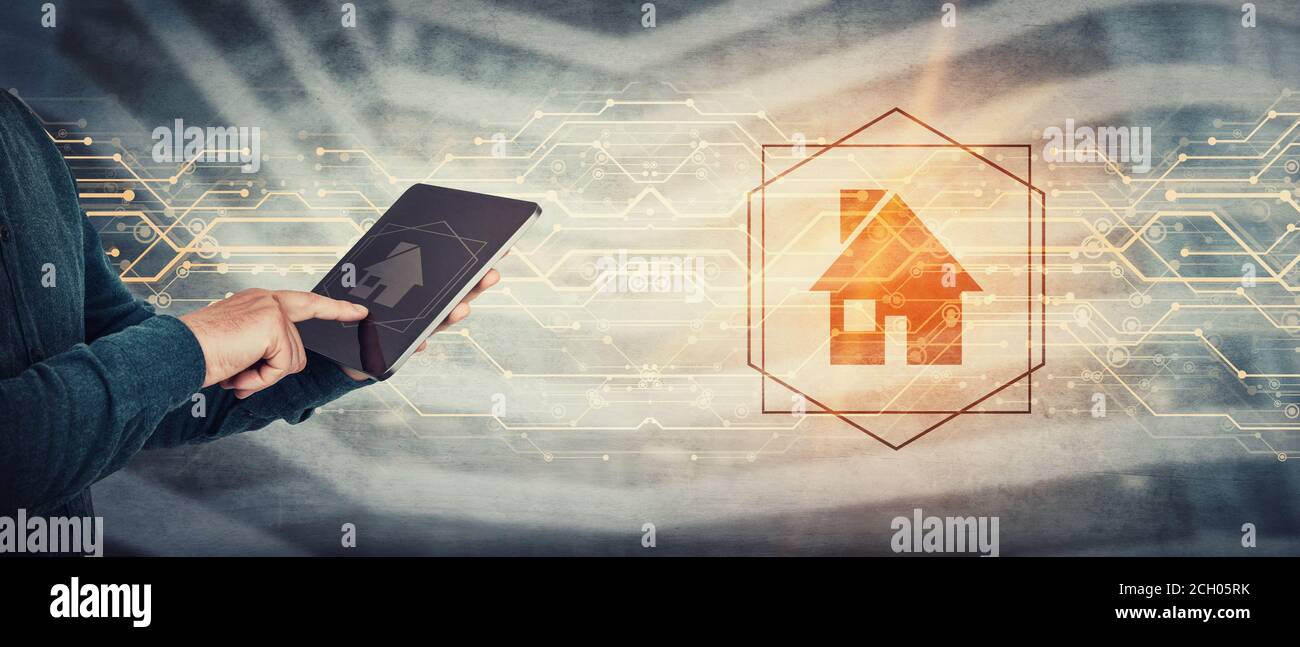 Working and studying from home conceptual background. Close up person hands using tablet computer gadget, press the PC screen to display a digital hou Stock Photo