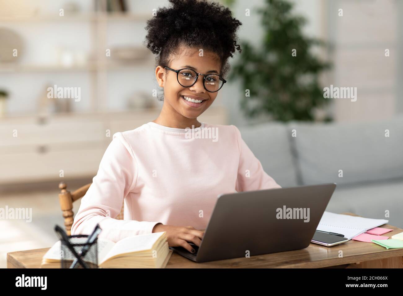 Black Teen Girl At Laptop Learning Online Sitting At Home Stock Photo ...