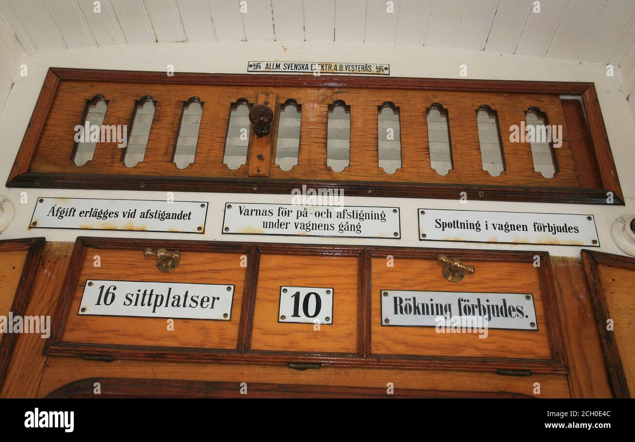HISTORIC TRAMS in Malmköping Sweden.Interior of one of the old carriages with signs inform about good behavior Stock Photo