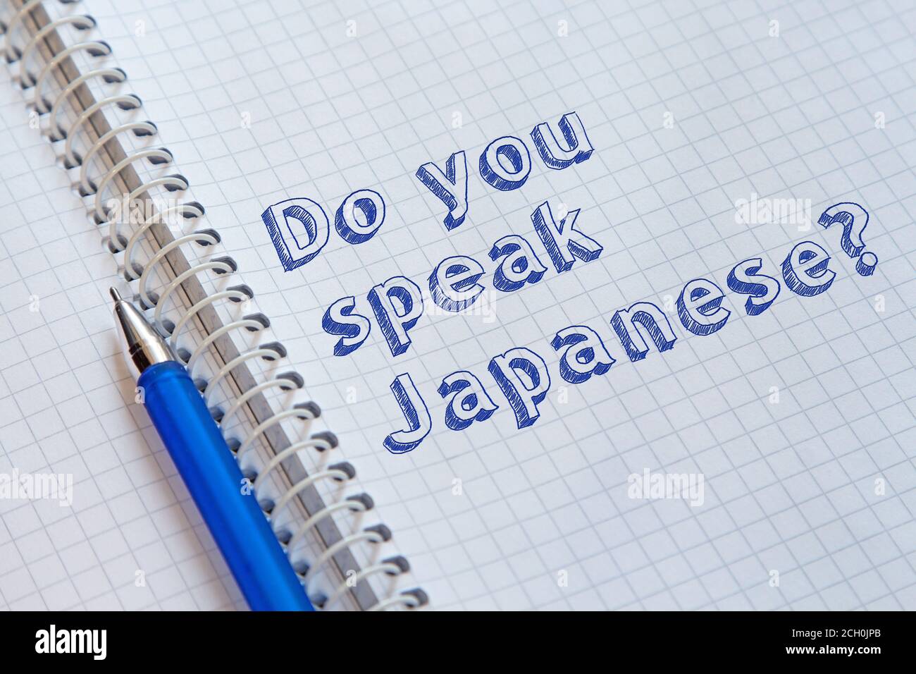 Do you speak Japanese? Text handwritten on sheet of notebook Stock Photo