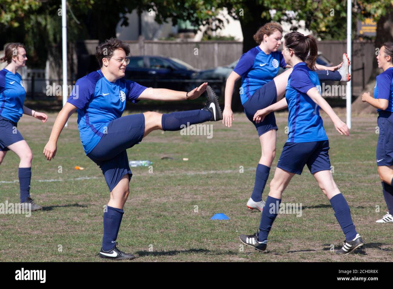 London, UK. 13 Sept 2020: A women's football team warm up in sunny weather on Clapham Common, London. New laws effective from tomorrow will ban groups of over 6 people meeting but organised sports are exempt from the rule. Anna Watson/Alamy Live News Stock Photo