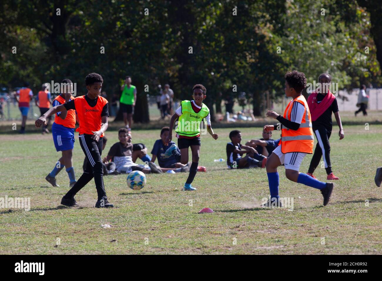 London, UK. 13 Sept 2020: Children took advantage of sunny weather to play football on Clapham Common, London. New laws effective from tomorrow will ban groups of over 6 people meeting but organised sports are exempt from the rule. Anna Watson/Alamy Live News Stock Photo