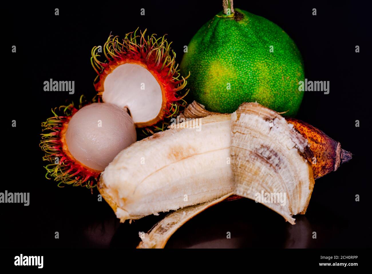 Colorful Rambutan, Banana and green CItrus in black background Stock ...