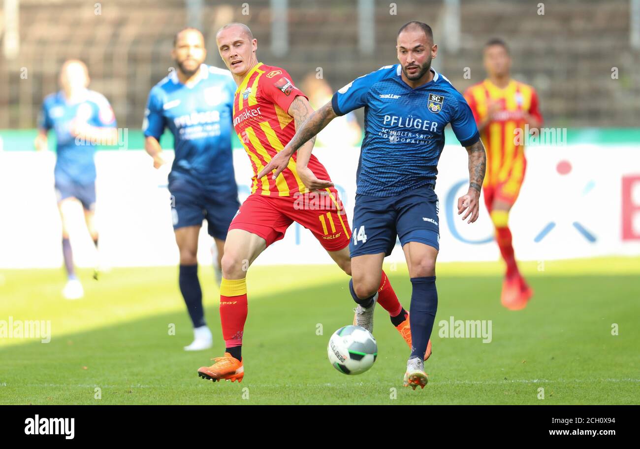 13 September 2020, North Rhine-Westphalia, Gütersloh: Football: DFB Cup, SC Wiedenbrück - SC Paderborn 07, 1st round. Saban Kaptan (r) from Wiedenbrück fighting for the ball with Sven Michel (l) from Paderborn. Photo: Friso Gentsch/dpa - IMPORTANT NOTE: In accordance with the regulations of the DFL Deutsche Fußball Liga and the DFB Deutscher Fußball-Bund, it is prohibited to exploit or have exploited in the stadium and/or from the game taken photographs in the form of sequence images and/or video-like photo series. Stock Photo