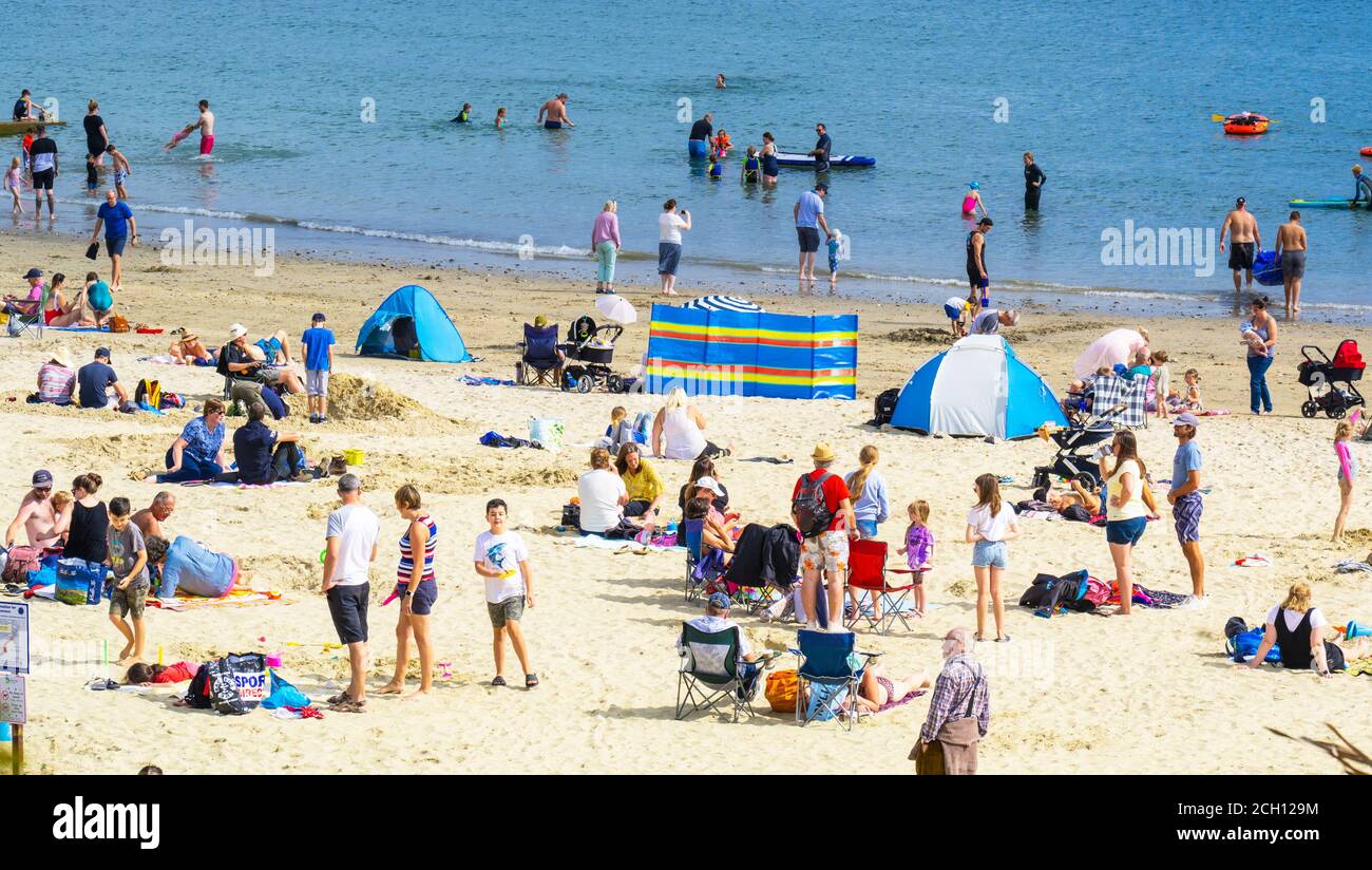 Lyme Regis, Dorset, UK. 13th September 2020. UK Weather: Visitors and locals flock to the seaside resort of Lyme regis to soak up scorching hot sunshine and blue skies as the mini-heatwave continues this afternoon. The warm tropical plume is set to see temperatures rising further into next week with the South Coast enjoing a balmy Indian summer.  Credit: Celia McMahon/Alamy Live News. Stock Photo