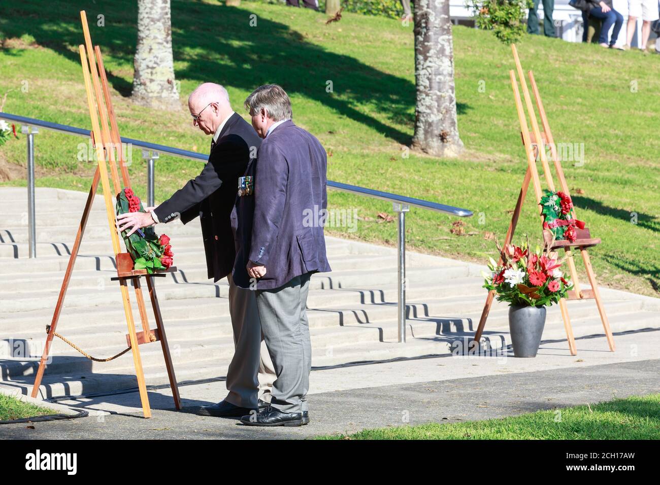 Anzac Day services in Tauranga, New Zealand. Two elderly veterans lay a wreath in Memorial Park. April 25 2018 Stock Photo