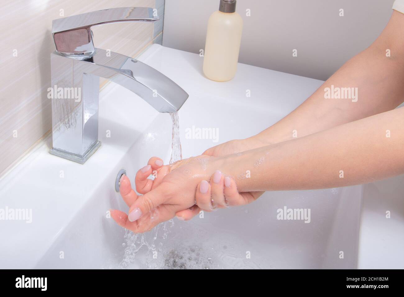 Woman washing with Soap hands thoroughly to Corona virus prevention. Hygiene concept. Washing frequently or using hand sanitizer gel Stock Photo