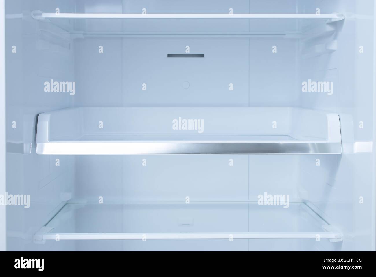 Inside of clean and empty refrigerator with shelves. background for health or diet concept. empty shelves for your products Stock Photo